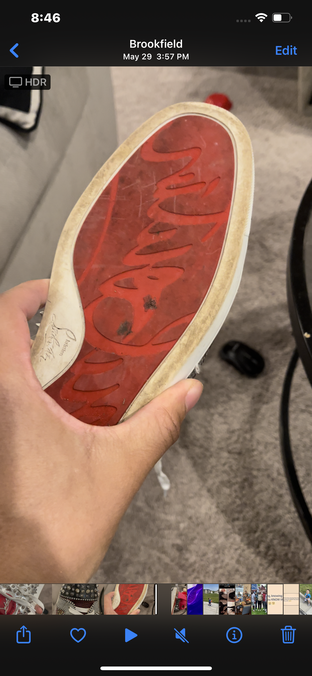 Dirty red-bottom sneaker outsole before repaint restoration